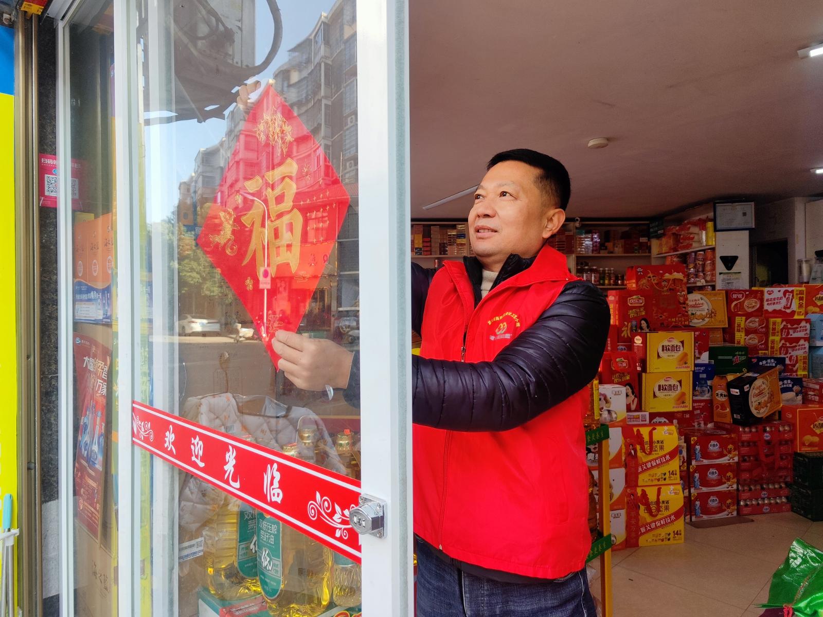 圖為客戶經(jīng)理幫助零售客戶裝飾店鋪迎新年.jpg